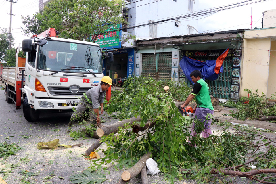 Người dân dọn dẹp, khắc phục hậu quả sau khi cơn bão đi qua.(Ảnh: Lê Ngọc Phước/TTXVN)
