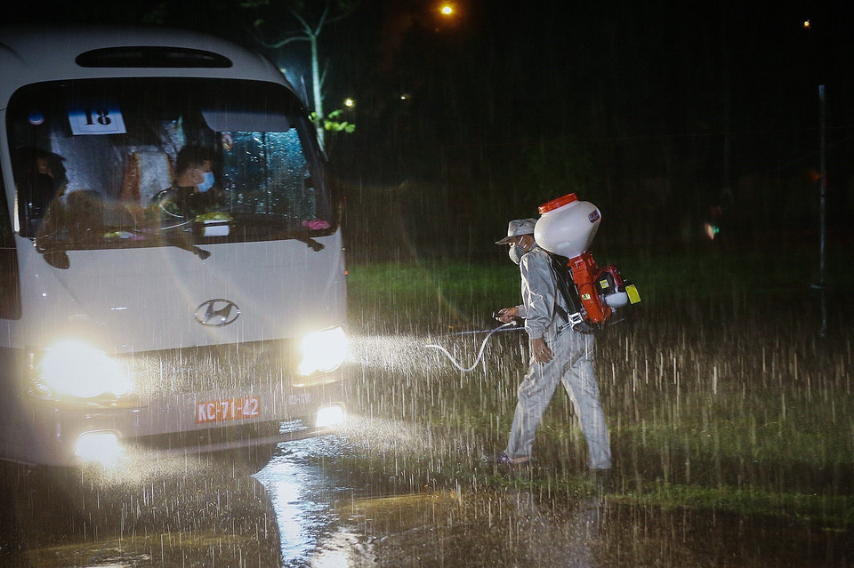  Phun thuốc khử trùng đoàn xe đưa các công dân từ vùng dịch về tới điểm cách ly, theo dõi tại Trường Quân sự tỉnh Hòa Bình, thuộc tổ 14, phường Thịnh Lang. (Ảnh: Trọng Đạt/TTXVN)