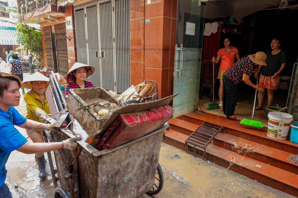 Người dân ngõ 823 đường Hồng Hà dọn dẹp nhà cửa, đến 12h ngày 14/9, nơi đây vẫn chưa có điện trở lại. (Ảnh: Hoàng Hiếu/TTXVN)