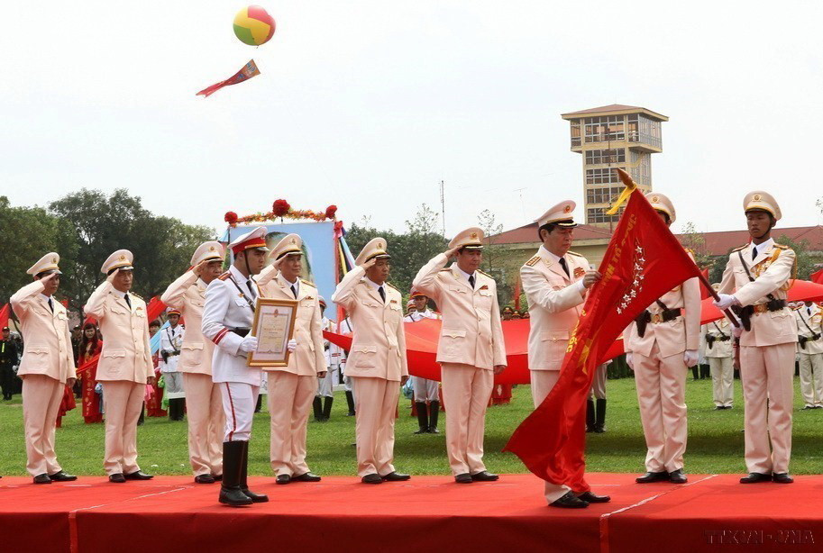 Đại tướng Trần Đại Quang, Bộ trưởng Bộ Công an trao tặng Huân chương Hồ Chí Minh của Chủ tịch nước cho lực lượng Cảnh sát Cơ động (Bộ Công an) tại Lễ míttinh kỷ niệm 40 năm Ngày truyền thống lực lượng Cảnh sát Cơ động (15/4/1974-15/4/2014). (Ảnh: Doãn Tấn/TTXVN)