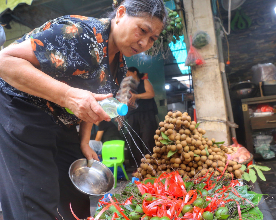 Liên tục tưới nước cho những quả cau được tươi xanh khi đến tay khách hàng. (Ảnh: Tuấn Đức/TTXVN)