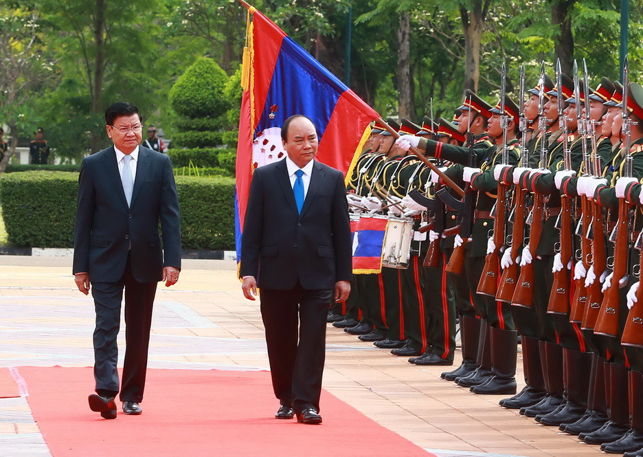Thủ tướng Nguyễn Xuân Phúc và Thủ tướng Lào Thongloun Sisoulith duyệt Đội danh dự. (Ảnh: Thống Nhất/TTXVN)