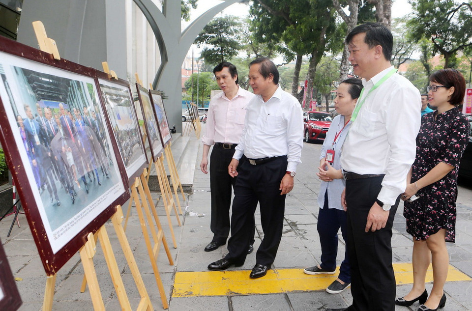 Bộ trưởng Bộ Thông tin và Truyền thông Trương Minh Tuấn và cán bộ, phóng viên TTXVN tham quan trưng bày ảnh Tuần lễ Cấp cao APEC 2017. (Ảnh: Doãn Tấn-TTXVN