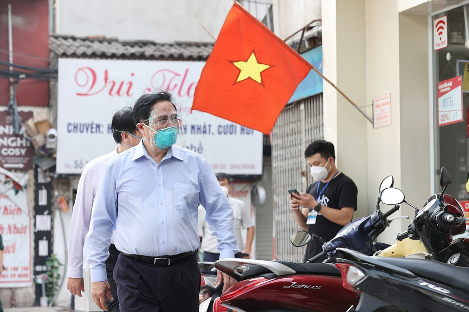 Thủ tướng Phạm Minh Chính thị sát điểm nóng về dịch bệnh COVID-19 tại quận Thanh Xuân. (Ảnh: Dương Giang/TTXVN)