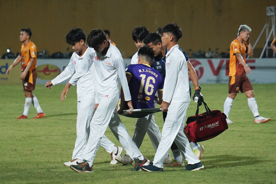 Hậu vệ Nguyễn Thành Chung bên phía Hà Nội FC rời sân sau khi gặp phải chấn thương. (Ảnh: Việt Anh/Vietnam+)