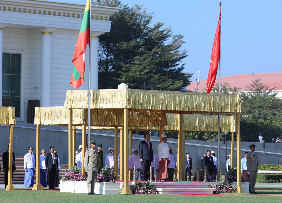 Thủ tướng Nguyễn Xuân Phúc và Tổng thống Win Myin nghe quân nhạc cử Quốc thiều hai nước. (Ảnh: Thống Nhất/TTXVN)