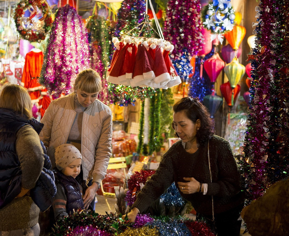 Du khách tham quan và chọn mua các mặt hàng trang trí đón Giáng sinh trên phố Hàng Mã. (Ảnh: Hoàng Hùng/TTXVN)