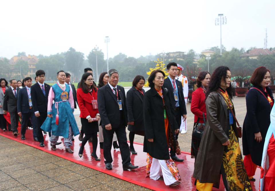 Đoàn kiều bào tiêu biểu dự chương trình 'Xuân quê hương' đặt vòng hoa và vào Lăng viếng Chủ tịch Hồ Chí Minh. (Ảnh: Dương Giang/TTXVN)