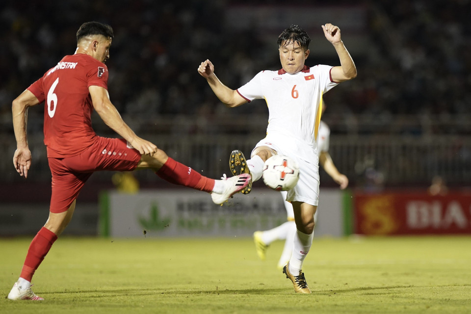 Pha tranh bóng giữa các tuyển thủ Việt Nam (áo trắng) với các cầu thủ Afghanistan (áo đỏ). (Ảnh: Thanh Vũ/TTXVN)