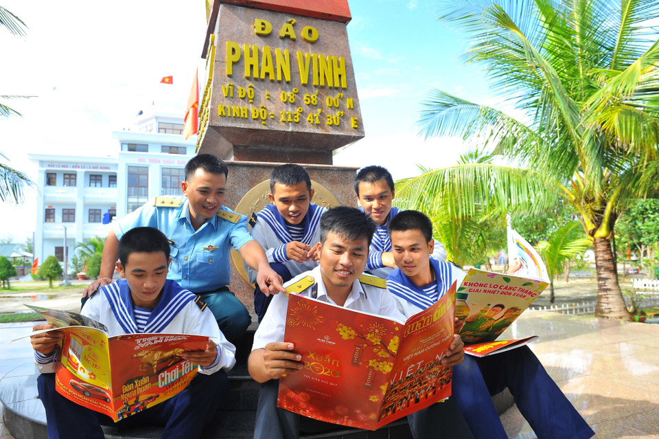 Các chiến sỹ đọc báo trên đảo Phan Vinh. (Ảnh: Minh Đức/TTXVN)