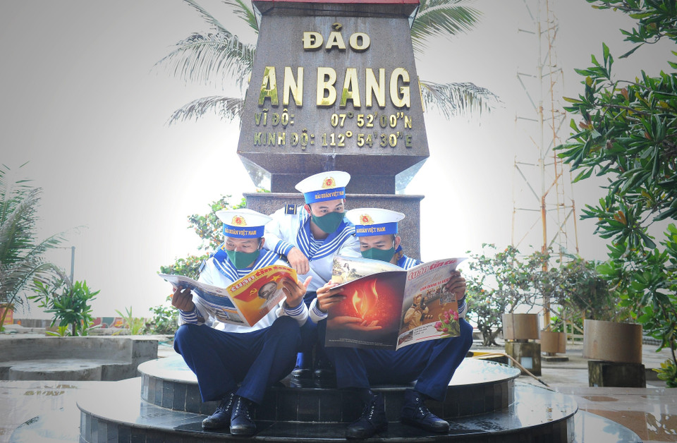 Các chiến sỹ đọc báo trên đảo An Bang. (Ảnh: Minh Đức/TTXVN)