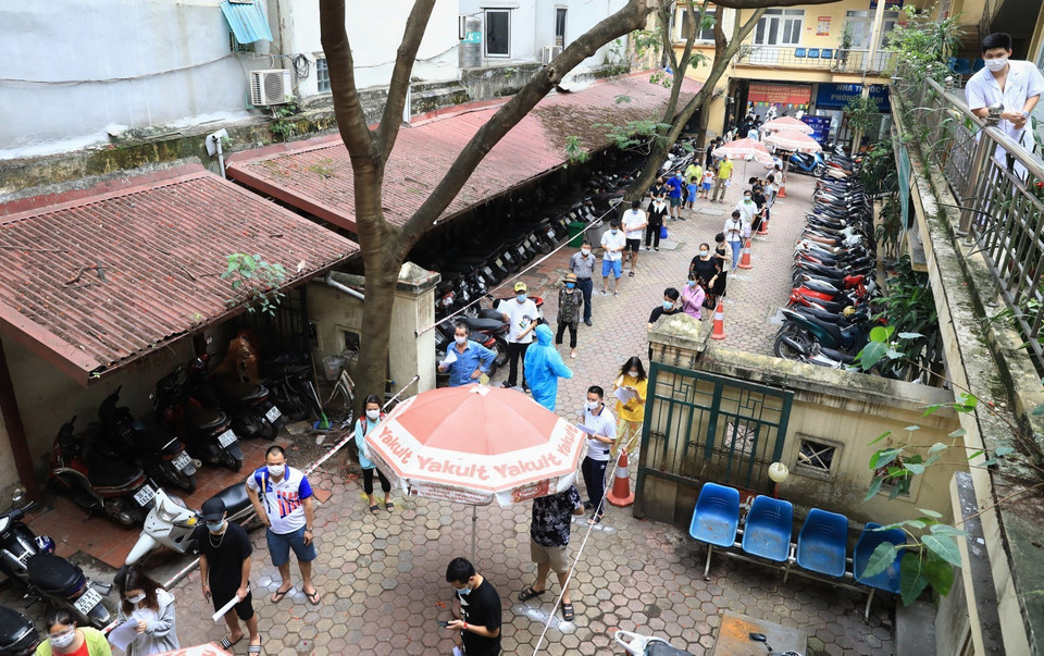 Tại quận Hoàn Kiếm, người dân đến làm xét nghiệm COVID-19 xếp hàng đảm bảo giãn cách theo quy định (ảnh chụp chiều 15/5). (Ảnh: Thành Đạt/TTXVN)