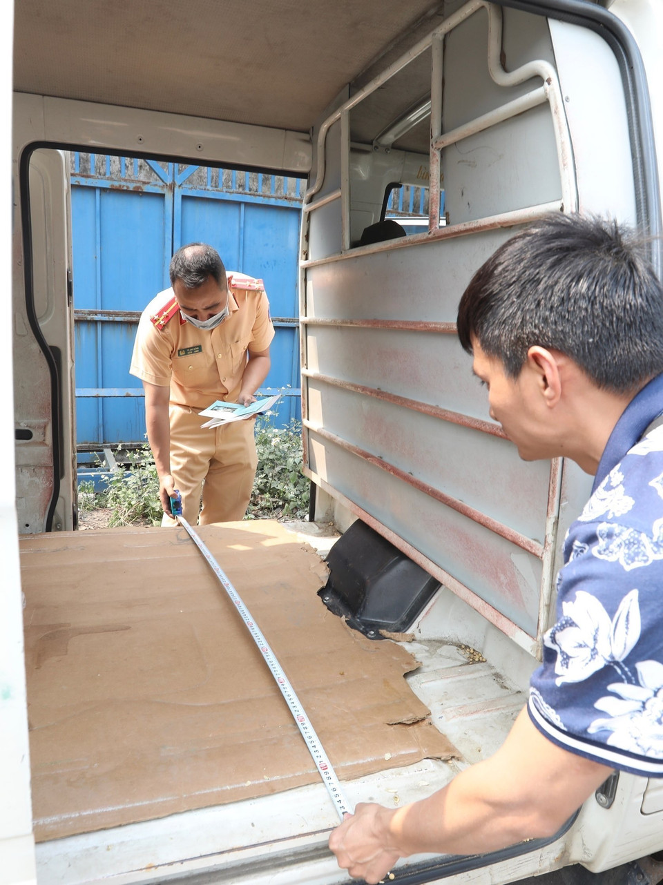 Đại úy công an Tô Anh Dũng (PC08 Nghệ An) kiểm tra xe đến đăng kiểm tại Trung tâm đăng kiểm xe cơ giới 2906V sáng 14/3. (Ảnh: Hoàng Hiếu/TTXVN)