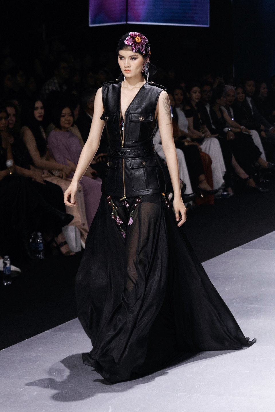 Cũng trong đêm đen ấy, xuất hiện le lói ánh sáng của cực quang được tái hiện qua tạo hình những đóa hoa tím xanh bằng đá lấp lánh được đính kết tỉ mỉ mang đến cảm giác bí ẩn, kích thích sự tò mò và khao khát khám phá những điều chưa được biết đến. (Ảnh: CTV/Vietnam+)