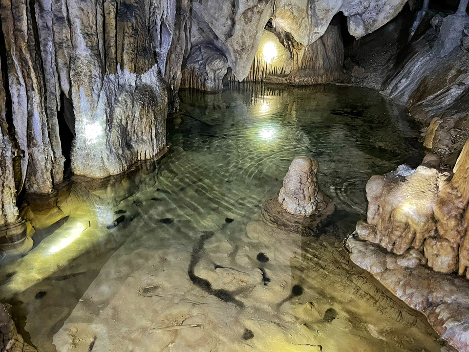 Đi vào sâu vào trong khoảng 40 mét, đường nước tràn hồ có một điểm ‘thắt cổ chai,’ ở đó thoảng nghe như có tiếng nước chảy, tiếng gió thổi. Có thể nhờ đó mà trong động dù có những lúc rất đông người nhưng không gây cảm giác thiếu ôxy, khó thở. (Ảnh: Mai Mai/Vietnam+)