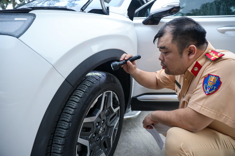 Cán bộ cảnh sát giao thông tập huấn công tác kiểm tra lốp và phanh của phương tiện. (Ảnh: TTXVN phát)
