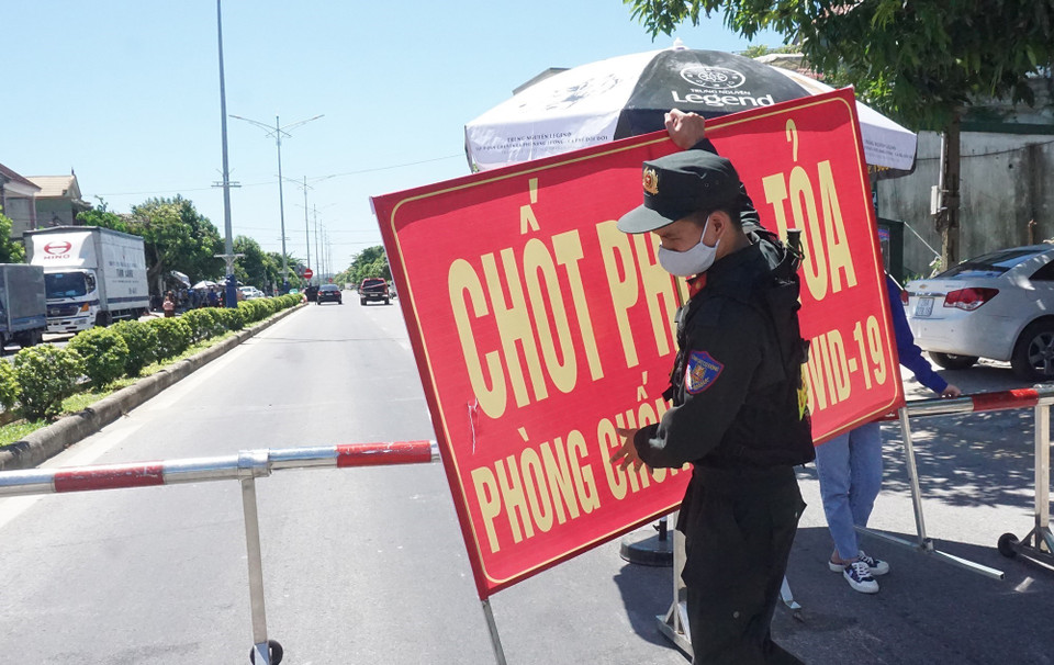 Cảnh sát cơ động làm nhiệm vụ trực chốt tại Quốc lộ 46 đoạn tiếp giáp giữa xã Hưng Chính (thành phố Vinh) và Khu công nghiệp VSIP (huyện Hưng Nguyên). (Ảnh: Bích Huệ/TTXVN)