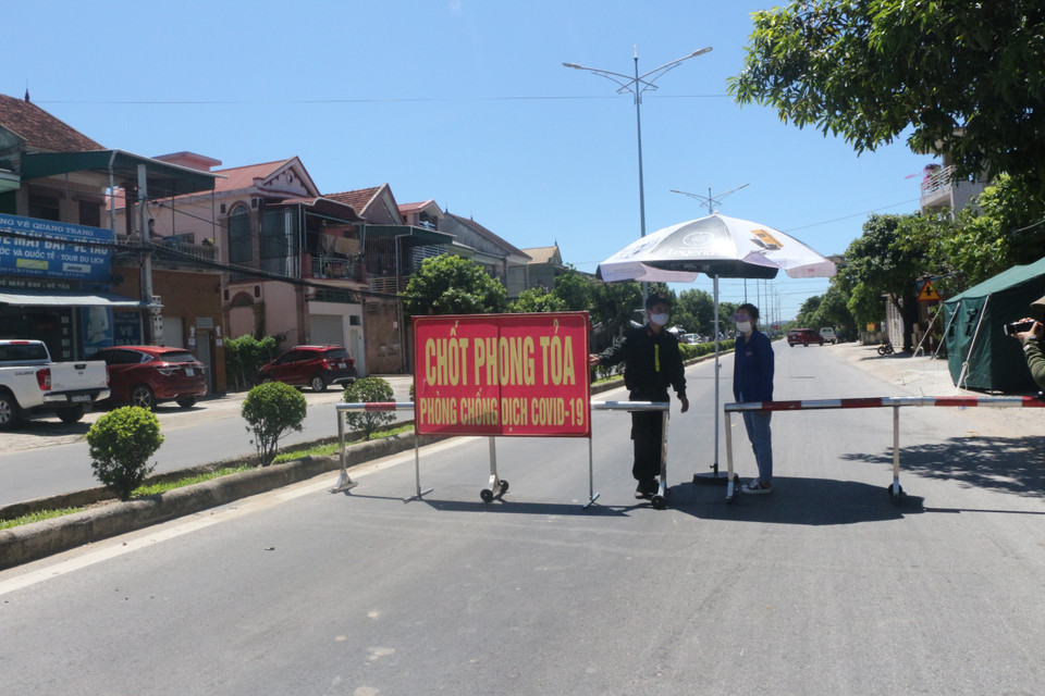 Lực lượng chức năng làm nhiệm vụ trực chốt tại Quốc lộ 46 đoạn tiếp giáp giữa xã Hưng Chính (thành phố Vinh) và Thị trấn huyện Hưng Nguyên. (Ảnh: Bích Huệ/TTXVN)