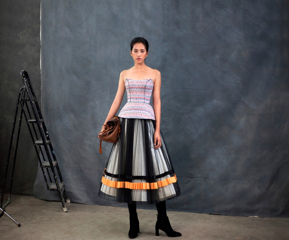 Chiếc áo màu be với tùng xếp ly được làm tỉ mỉ bằng những đường đột chỉ tay, kết hợp với chất liệu vải tweed – vốn rất được nhà thiết kế Công Trí ưa chuộng trong từng thiết kế của mình khiến cho hình ảnh Tiểu Vy trở nên sang trọng mà không hề nhàm chán. (Ảnh: Danny Son Pham/Vietnam+)