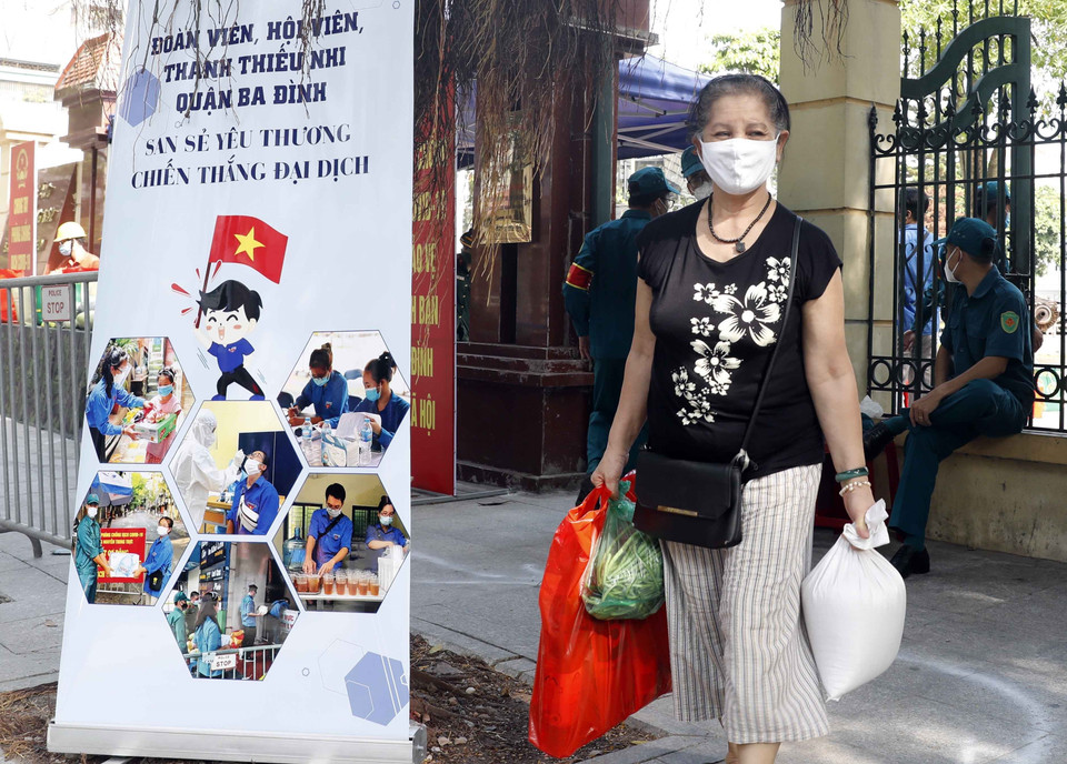 Người dân có hoàn cảnh khó khăn nhận những suất quà từ gian hàng 0 đồng. (Ảnh: Trần Việt/TTXVN)