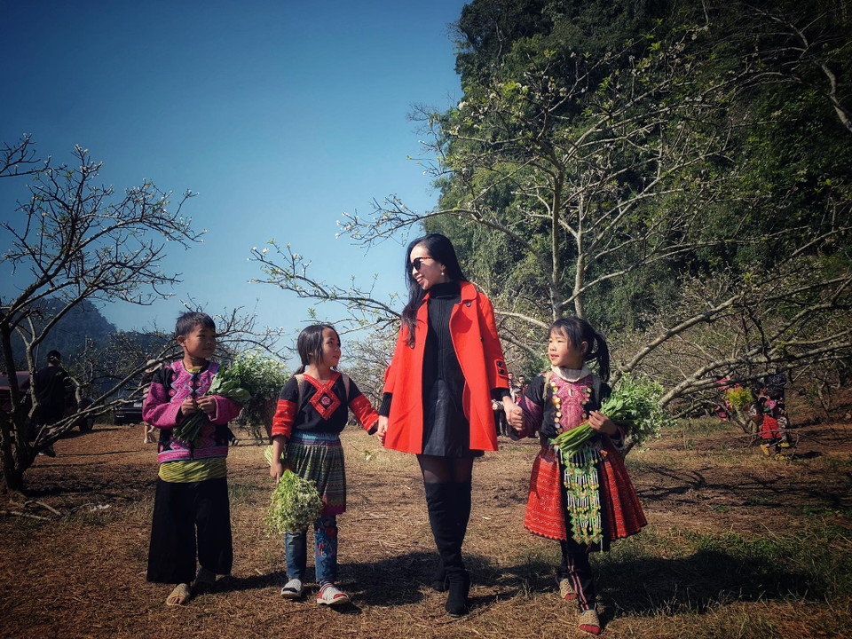 Chị Kiều Liên, du khách đến từ Hà Nội rất thích thú khi vào rừng mơ được gặp những đứa trẻ dân tộc hồn nhiên và sắc màu tươi vui. (Ảnh: Xuân Mai/Vietnam+)