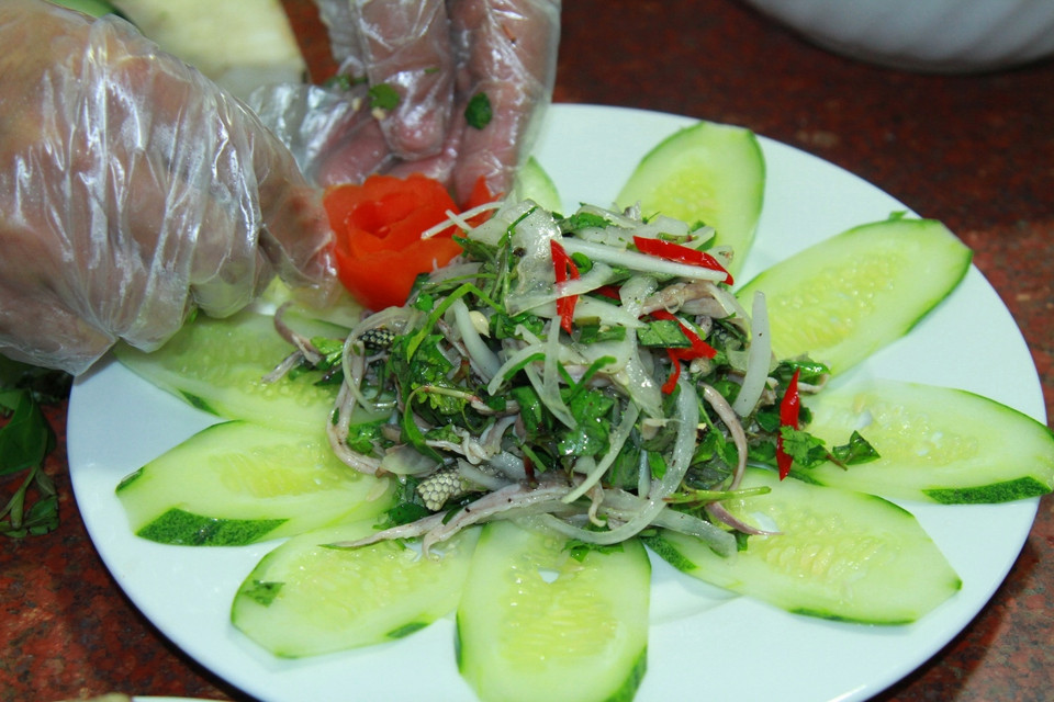 Trộn với hành tây, răm, ớt, mùi, húng... và gia vị. (Ảnh: Xuân Mai/Vietnam+)