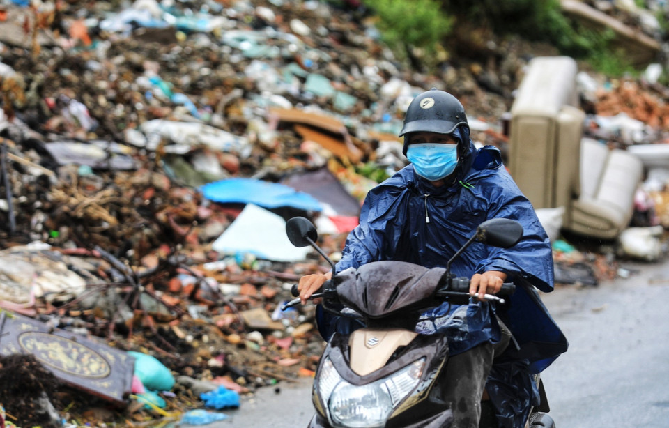Trời mưa khiến rác càng bốc mùi hôi thối, gây mất vệ sinh môi trường và ảnh hưởng đến những người đi ngang qua đây. (Ảnh: Thành Đạt/TTXVN)