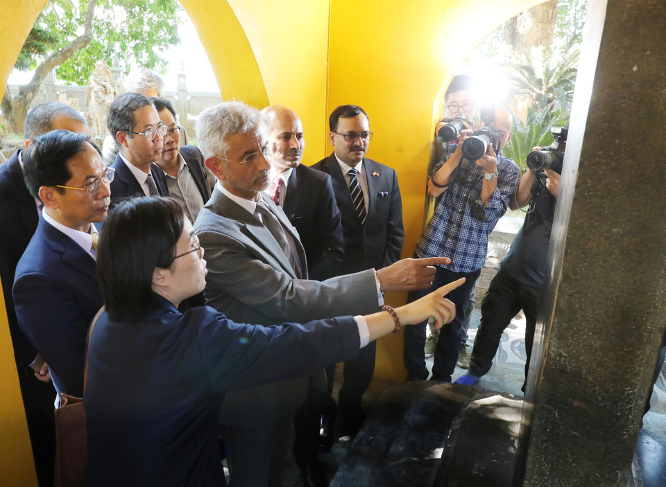 Bộ trưởng Ngoại giao Bùi Thanh Sơn và Bộ trưởng Ngoại giao Ấn Độ Subrahmanyam Jaishankar tham quan bia đá giới thiệu cây bồ đề do Tổng thống Ấn Độ Rajendra Prasad trao tặng Chủ tịch Hồ Chí Minh (năm 1959) được trồng tại chùa Trấn Quốc. (Ảnh: Lâm Khánh/TTXVN)