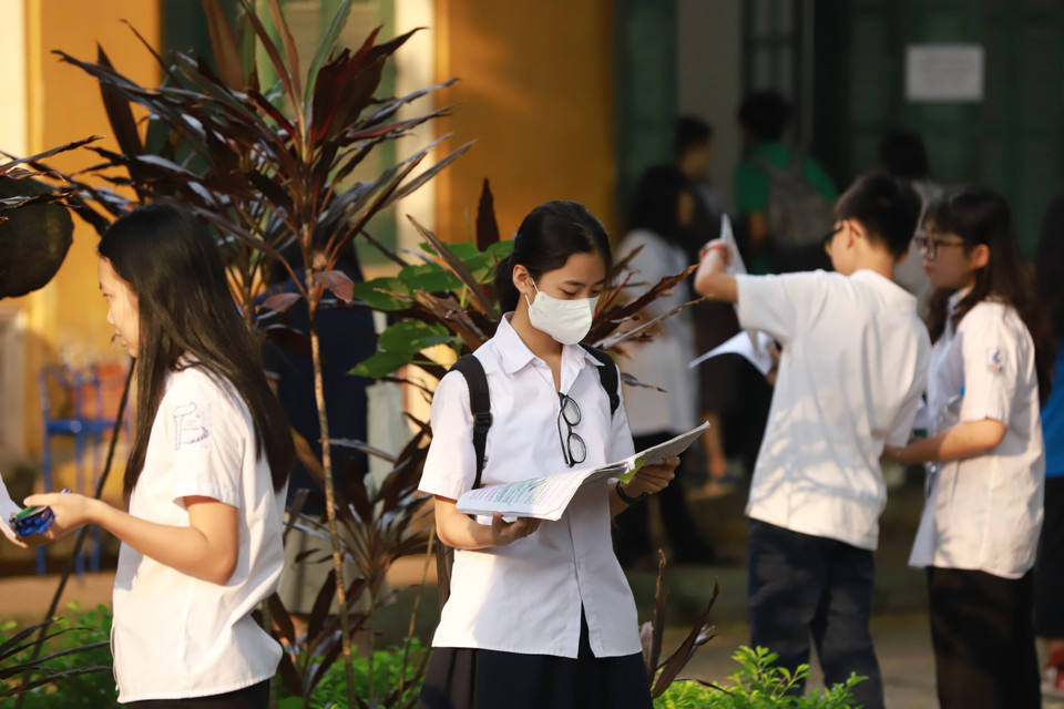 Nhiều thí sinh tranh thủ ôn lại các bài văn trước khi vào phòng thi. (Ảnh: PV/Vietnam+)