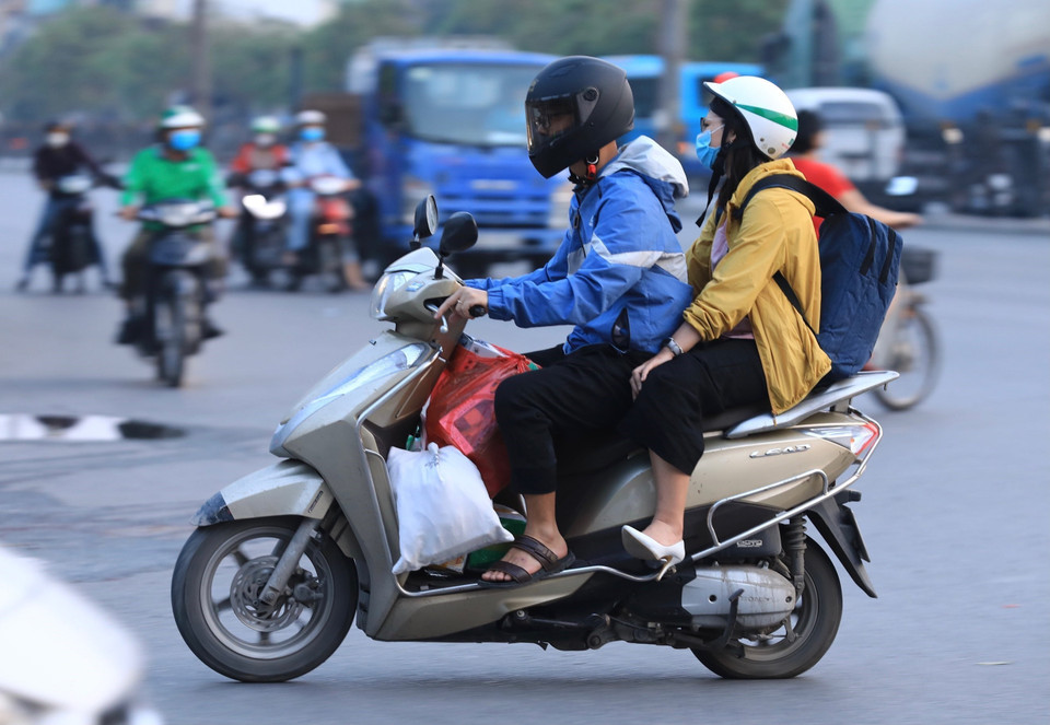 Người và phương tiện với balô, túi xách trên đường hướng đi Quốc lộ 1. (Ảnh: Hoàng Hiếu/TTXVN)