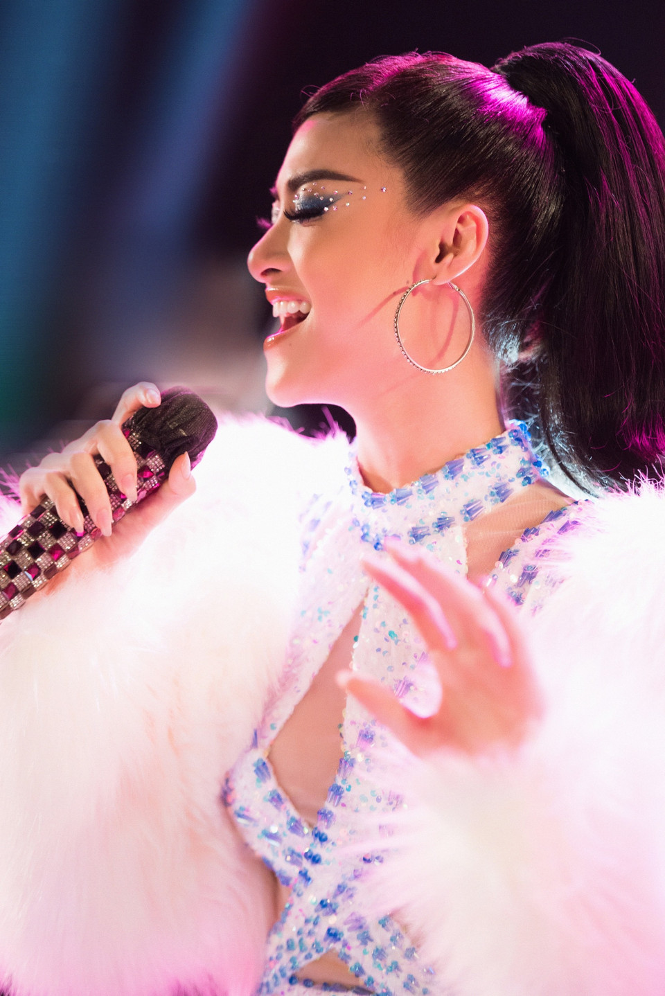 Giữa không gian âm nhạc mang màu sắc disco, Kiều Loan hóa thành quý cô sang chảnh với lối trang điểm có phần mắt đính hạt lấp lánh. Đặc biệt, nàng Á hậu còn nhấn nhá bộ trang phục với chiếc áo lông trắng tôn thêm phần gợi cảm. (Ảnh: CTV/Vietnam+)