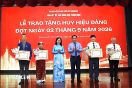 Trao Huy hiệu 45 năm tuổi Đảng cho các đảng viên. (Ảnh: Liên Sơn/TTXVN)