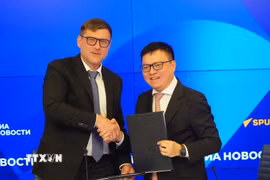 Tổng Biên tập Báo Nhân Dân Lê Quốc Minh ký thỏa thuận với Tập đoàn Truyền thông Rossiya Segodnya. (Ảnh: Tâm Hằng/TTXVN)