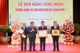 Ông Nguyễn Xuân Thắng trao Bằng công nhận đạt chuẩn mức độ 1 cho Ban Giám hiệu nhà trường. (Ảnh: Trung Kiên/TTXVN)