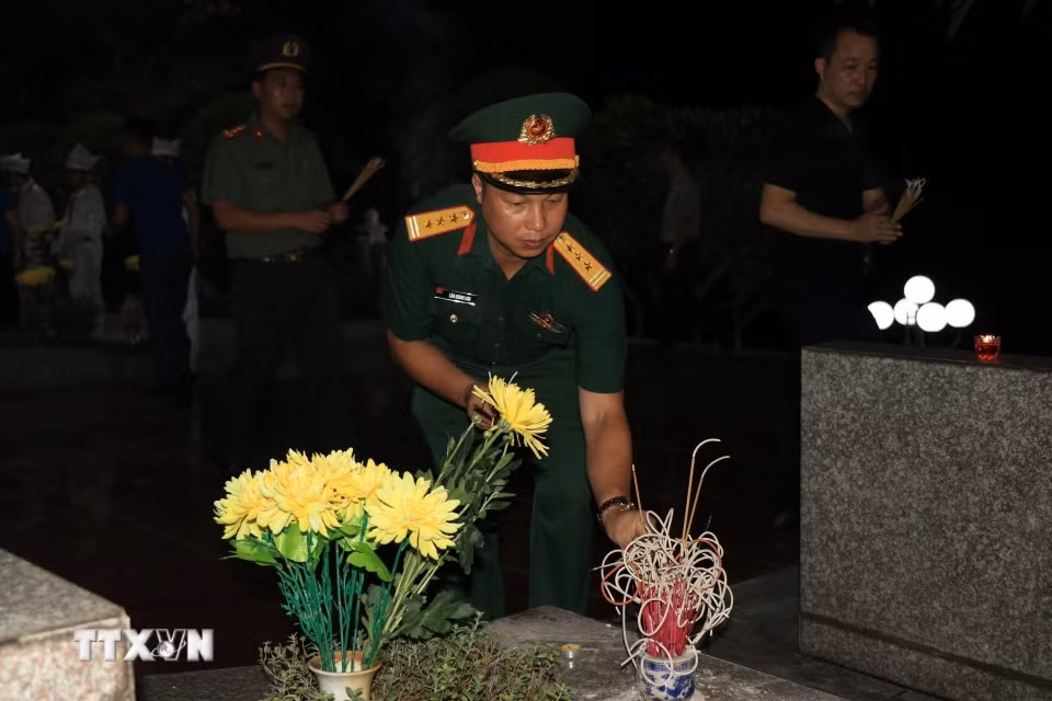 Thanh niên Lào Cai dâng hương và thắp nến tri ân các Anh hùng liệt sỹ. (Ảnh: Đinh Thùy/TTXVN)