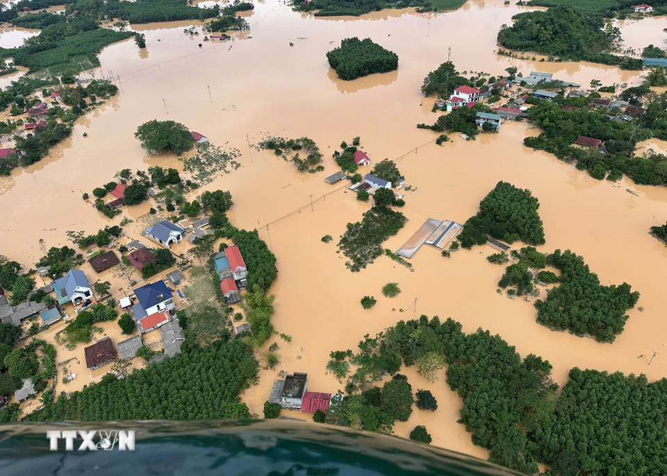 Các vùng lũ bị cô lập được trực thăng thả hàng cứu trợ. (Ảnh: TTXVN phát)