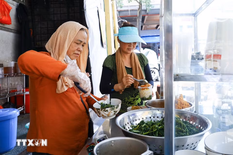 Quán ăn khu vực chợ Đồng Xuân, Hà Nội tất bật phục vụ khách giữa trời nắng nóng. (Ảnh: Lê Đông/TTXVN)