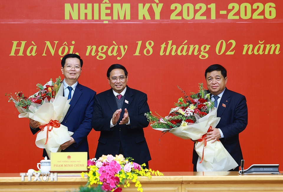 Thủ tướng Phạm Minh Chính tặng hoa chúc mừng Phó Thủ tướng Mai Văn Chính và Phó Thủ tướng Nguyễn Chí Dũng. (Ảnh: Dương Giang/TTXVN)