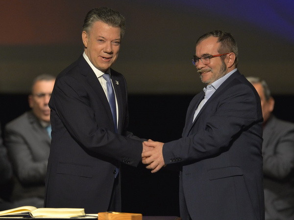Tổng thống Colombia Juan Manuel Santos (trái) và thủ lĩnh tối cao FARC Timoleon Jimenez. (Nguồn: AFP/TTXVN) Liên hợp quốc hoan nghênh thỏa thuận hòa bình sửa đổi tại Colombia ảnh 1