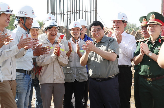 Thủ tướng Phạm Minh Chính với kỹ sư, công nhân, người lao động đang thi công đường Vành đai 3 đoạn qua Thành phố Hồ Chí Minh. (Ảnh: Dương Giang/TTXVN) ttxvn_1302_pham minh chinh vanh dai 3 (2).jpg
