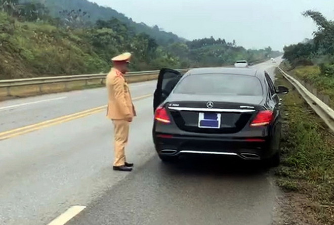 Cảnh sát giao thông dừng chiếc xe Mercedes che biển số sáng 11/1. (Nguồn: vnexpress.net) Dán băng dính che biển số, tài xế bị xử phạt ở cao tốc Nội Bài-Lào Cai ảnh 1
