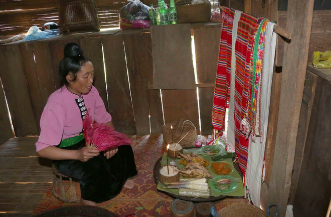 Thực hiện nghi lễ mời các vị thần linh thổ địa, linh hồn tổ tiên về dự và nhận các lễ vật của gia chủ. (Ảnh: Quang Quyết/TTXVN) ttxvn_nguoi Xinh Mun1.jpg
