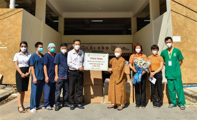 Thượng tọa Thích Nhật Từ (thứ 4 từ phải sang) thay mặt Quỹ Đạo Phật Ngày nay - Chùa Giác Ngộ trao tặng Bệnh viện Dã chiến 3 máy sốc nhịp tim và máy thở. (Ảnh: TTXVN phát) Tăng, ni, phật tử TP.HCM tích cực hỗ trợ phòng, chống dịch COVID-19 ảnh 2
