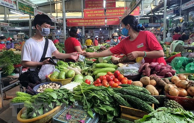 Ảnh minh họa. (Nguồn: TTXVN) TP.HCM: Mở cửa theo lộ trình và nguyên tắc, đảm bảo 'mục tiêu kép' ảnh 1