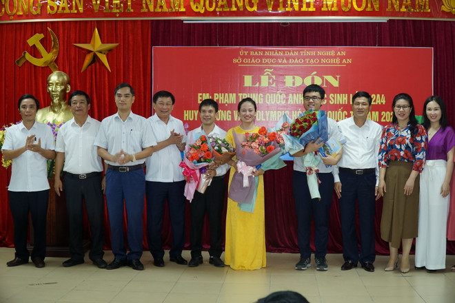 Niềm vui của cô Trần Thị Quỳnh Anh cùng với em Phạm Trung Quốc Anh (cầm hoa bên phải), Huy chương Vàng Olympic Hóa học quốc tế. (Ảnh: Bích Huệ/TTXVN) Giữ yêu thương, trách nhiệm với từng khóa học sinh của cô giáo trẻ ảnh 2