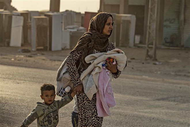 Người dân Syria sơ tán tránh chiến sự ở thị trấn Ras al-Ain, tỉnh Hasakeh (Syria). (Ảnh: AFP/TTXVN) Thảm họa nhân đạo trong ''vũng lầy chính trị'' tại Syria ảnh 2