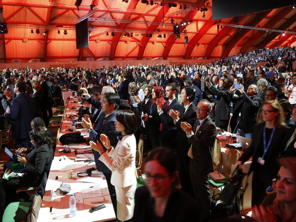 Các đại biểu hoan nghênh quyết định thông qua Thỏa thuận Paris 2015 về chống biến đổi khí hậu tại Le Bourget ngày 12/12 vừa qua. (Ảnh: AFP/TTXVN) Lượng khí thải gây hiệu ứng nhà kính của Australia vẫn đang tăng ảnh 1