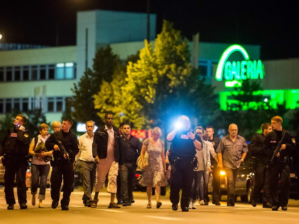 Người dân được sơ tán khỏi hiện trường vụ xả súng ở Munich tối 22/7. (Ảnh: AFP/TTXVN) Chưa có thông tin người Việt gặp nạn trong vụ tấn công ở Munich ảnh 1