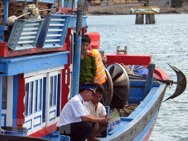 Lực lượng chấp pháp trên biển của Ninh Thuận tuyên truyền cho ngư dân về các quy định pháp luật trong đánh bắt hải sản (Ảnh: Công Thử/TTXVN) Thẻ vàng: Giải pháp nào siết chặt kiểm tra, giám sát tàu cá hiệu quả? ảnh 2