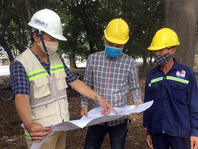 Đơn vị xem xét bản vẽ, triển khai các bước thực hiện dự án xây dựng dự án. (Ảnh: Tiến Lực/TTXVN) TP.HCM: Hơn 830 tỷ đồng xây dựng hầm chui nút giao thông ở quận 7 ảnh 2
